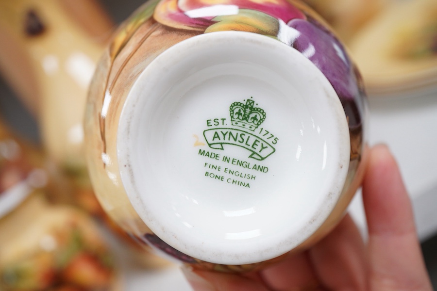 A collection of Aynsley Orchard Gold wares including a timepiece, vases, etc. tallest 23cm